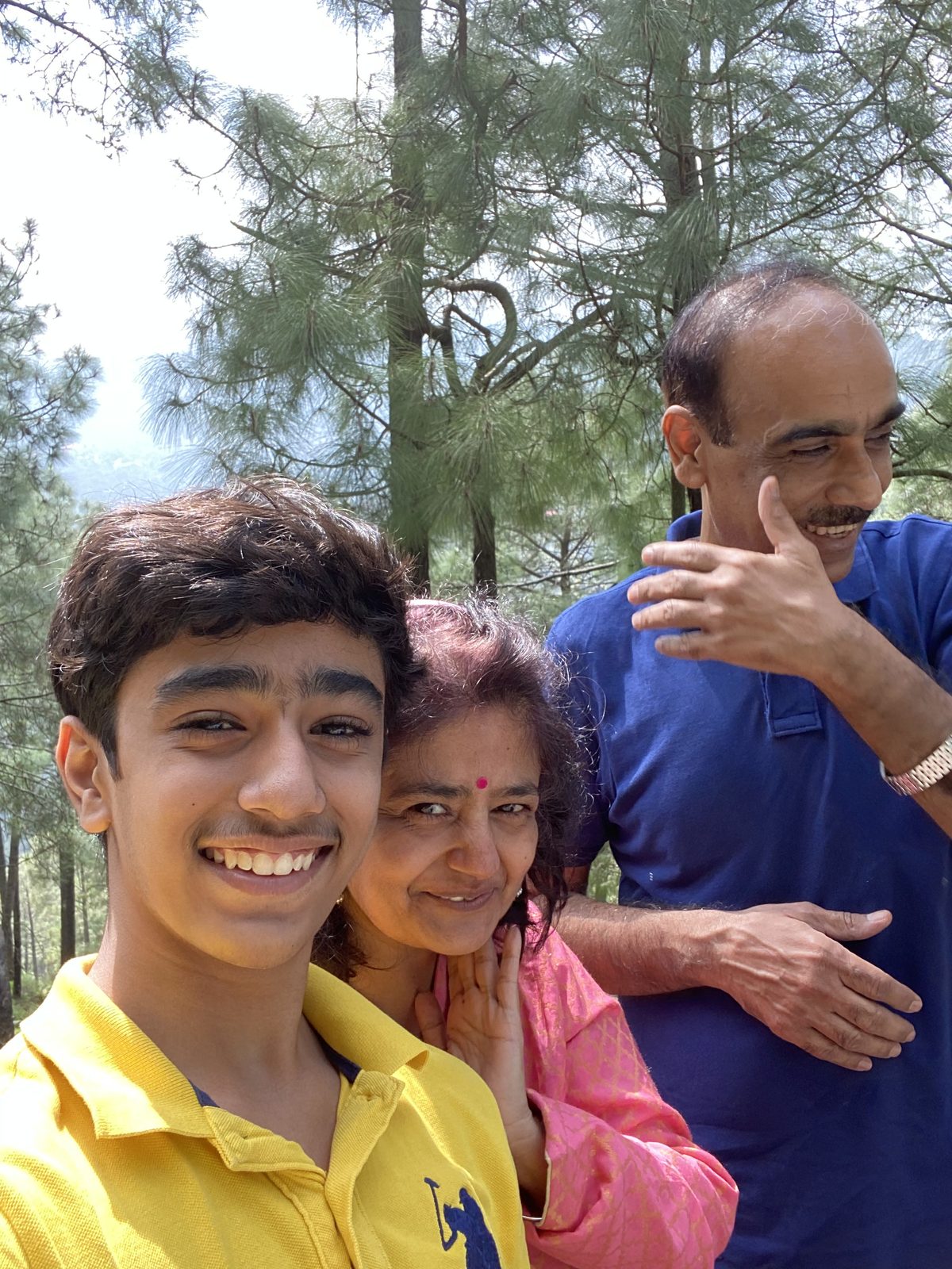 A family selfie among the pines