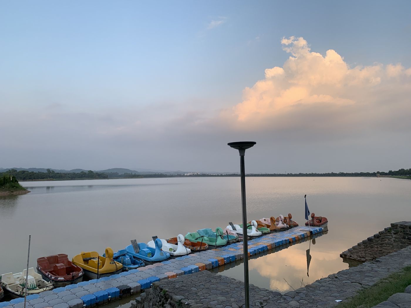Boats on a calm lake at sunset