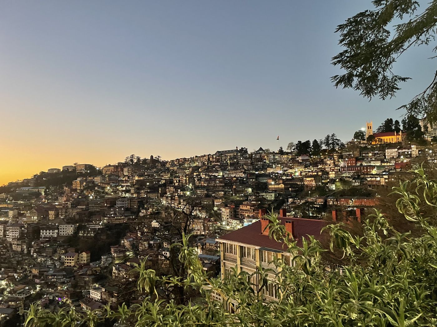Shimla hillside at dusk with lights coming on