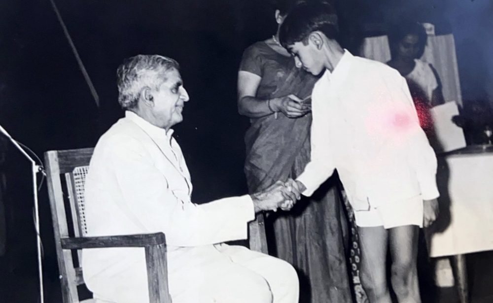 A young Rajiv Sachdev receiving a school prize