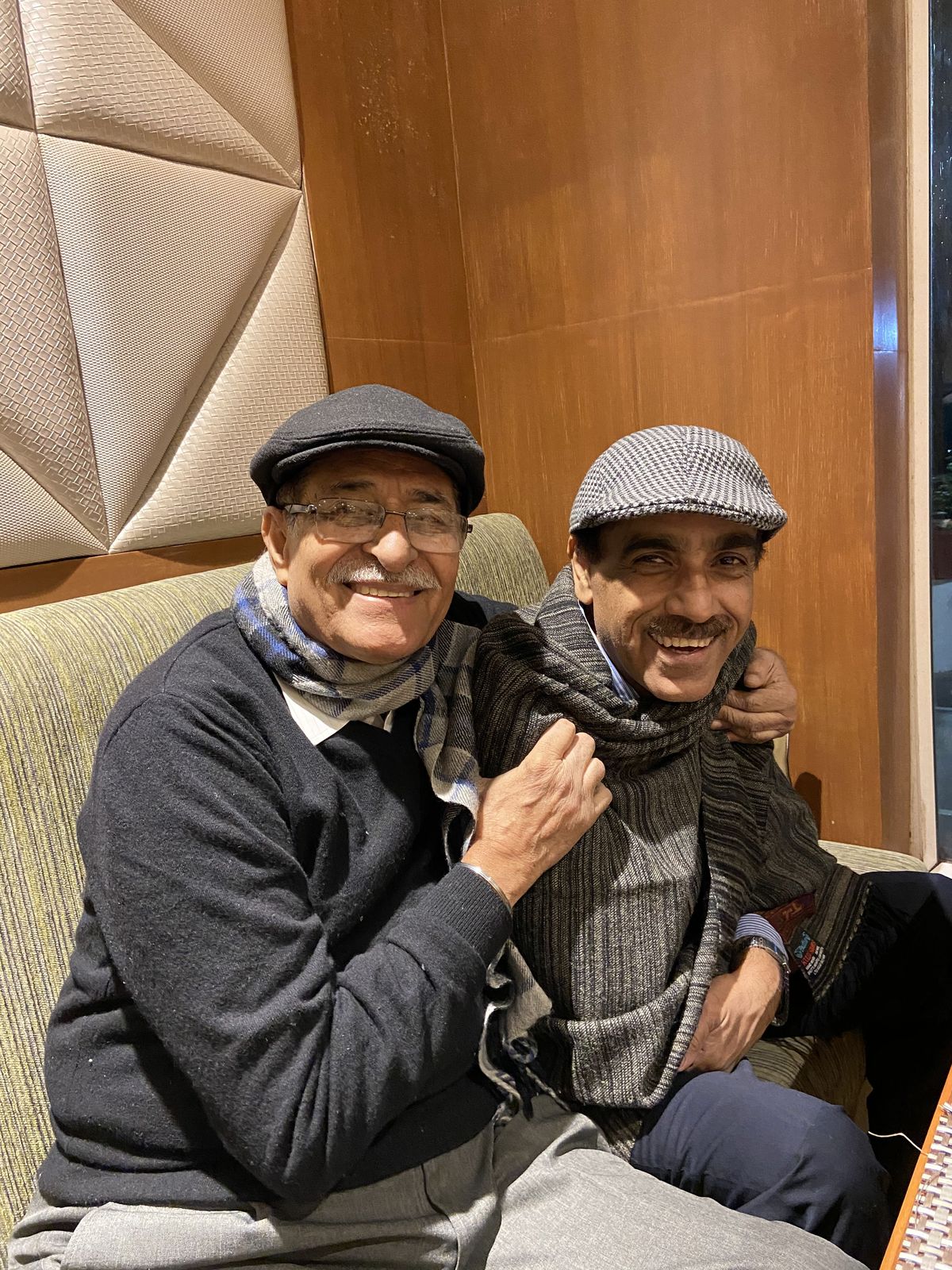 Rajiv Sachdev sharing a laugh with a dear companion, both in winter caps