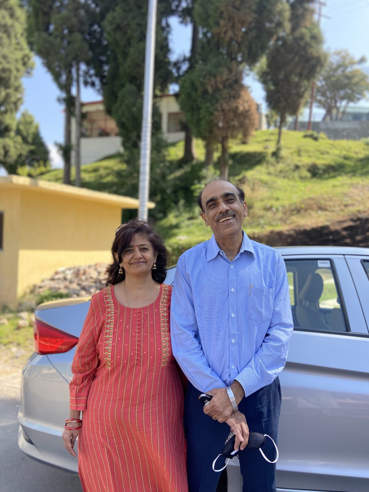 Rajiv Sachdev with his wife on a sunny mountain day